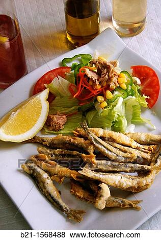 Stock Photo - ? Boquerones fritos? fried anchovies with salad, a typical meal from Malaga, Andalusia, Spain. Fotosearch