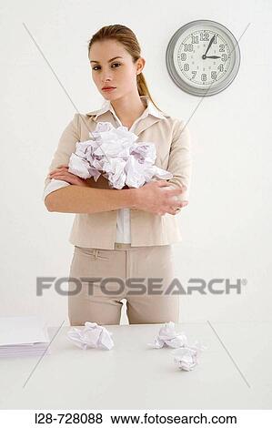 Stock Photo - Bored businesswoman holding Crumpled paper. Fotosearch