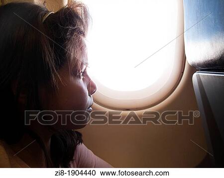 Stock Image - Bored child on long haul flight. Fotosearch