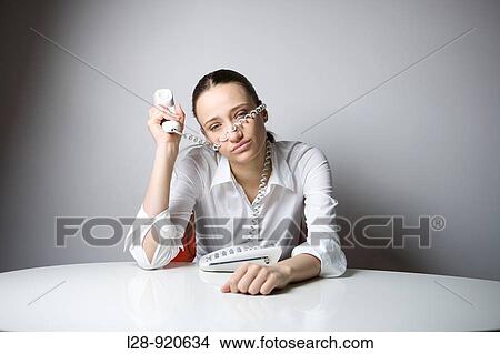 Bored Worker Office Woman playing with phone View Large Photo Image Picture - Bored Worker Office Woman playing with phone. Fotosearch