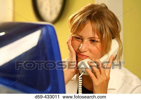 Bored young woman on phone, in front of computer. View Large Photo Image Stock Image - Bored young woman on phone, in front of computer.. Fotosearch