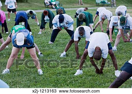 Stock Image - Boston, Massachusetts - Members of the public employees union AFSCME do stretching exercises before a 5K fun run during their union's convention. Fotosearch