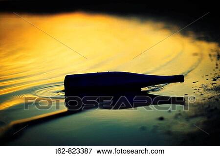 Bottle and its reflection in the water Color View Large Photo Image Stock Photo - Bottle and its reflection in the water Color. Fotosearch