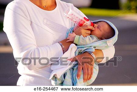 Stock Photo - bottle feeding infant. Fotosearch