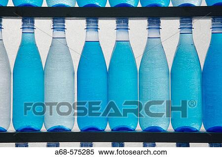 Bottles filled with blue water View Large Photo Image Stock Photography - Bottles filled with blue water. Fotosearch