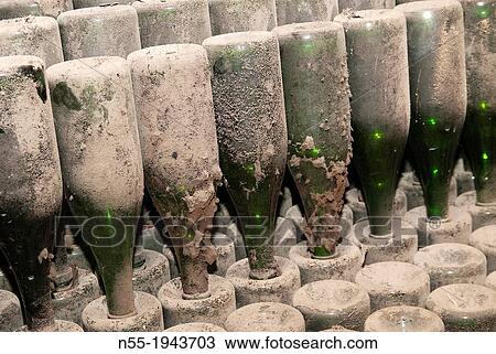 Stock Image - Bottles of??cava?? in an old abandoned wine cellar. Vilafranca del Pened? s. Catalonia. Spain.. Fotosearch
