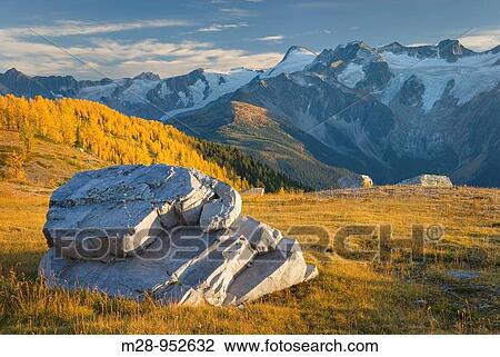 Stock Image - Boulders in Monica Meadows, the peaks of the Truce Group are in the distance, Purcell Mountains British Columbia Canada. Fotosearch