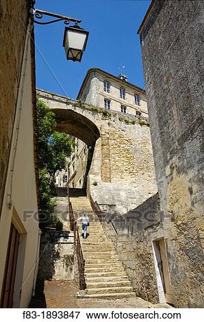 Bourg Bourg-sur-Gironde, in the Dordogne River Valley at the convergence of the Garonne and Dordogne Rivers, Gironde department, Acquitaine, France: stairway leads to a gateway in the medieval town wall, 63 year old woman on steps, May model released View Large Photo Image Stock Photo - Bourg Bourg-sur-Gironde, in the Dordogne River Valley at the convergence of the Garonne and Dordogne Rivers, Gironde department, Acquitaine, France: stairway leads to a gateway in the medieval town wall, 63 year old woman on steps, May model released. Fotosearch
