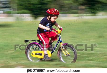 Boy, 4 years old, riding a bicycle View Large Photo Image Stock Photo - Boy, 4 years old, riding a bicycle. Fotosearch