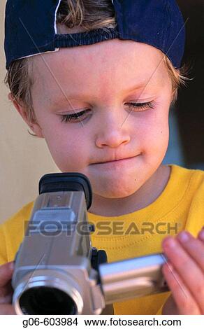 Boy, 4 years old, using video camera View Large Photo Image Picture - Boy, 4 years old, using video camera. Fotosearch
