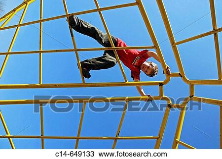 Stock Image - Boy, 7 years, climbing, Cologne, NRW, Germany. Fotosearch