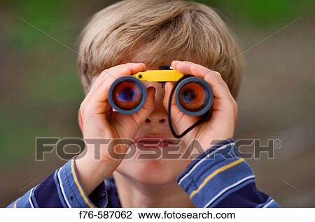 Boy, 8 years old, looking through binoculars. View Large Photo Image Stock Image - Boy, 8 years old, looking through binoculars.. Fotosearch