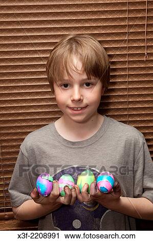Boy age 11 holding his newly dyed Easter eggs. St Paul Minnesota MN USA. View Large Photo Image Stock Image - Boy age 11 holding his newly dyed Easter eggs. St Paul Minnesota MN USA.. Fotosearch
