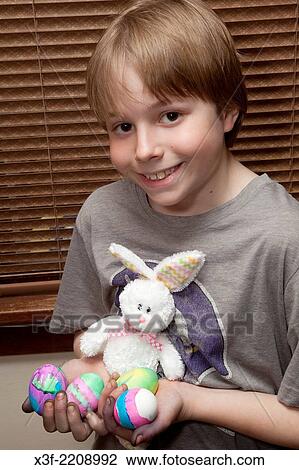 Boy age 11 holding his newly dyed Easter eggs and stuffed bunny. St Paul Minnesota MN USA. View Large Photo Image Stock Image - Boy age 11 holding his newly dyed Easter eggs and stuffed bunny. St Paul Minnesota MN USA.. Fotosearch