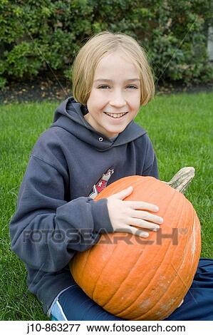 Boy, age 11, with pumpkin, Poughkeepsie, New York, USA View Large Photo Image Stock Photo - Boy, age 11, with pumpkin, Poughkeepsie, New York, USA. Fotosearch