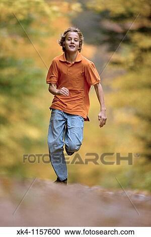 Stock Image - Boy Age 12 Running - Upstate New York in Autumn - USA.. Fotosearch