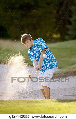 Boy, age 14, hitting out of sandtrap on golf course. McCall, Idaho USA View Large Photo Image Stock Photography - Boy, age 14, hitting out of sandtrap on golf course. McCall, Idaho USA. Fotosearch
