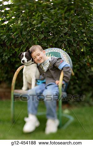 Boy, age five, and Jack Russell Terrier dog sit on decorative chair. View Large Photo Image Stock Photo - Boy, age five, and Jack Russell Terrier dog sit on decorative chair.. Fotosearch