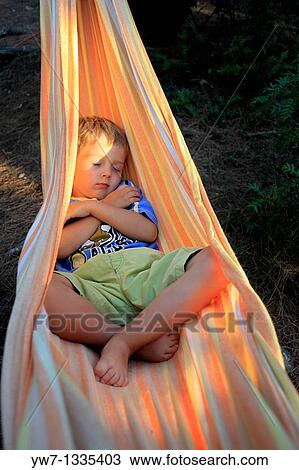 Boy aged 4 resting in a hammock View Large Photo Image Stock Image - Boy aged 4 resting in a hammock. Fotosearch