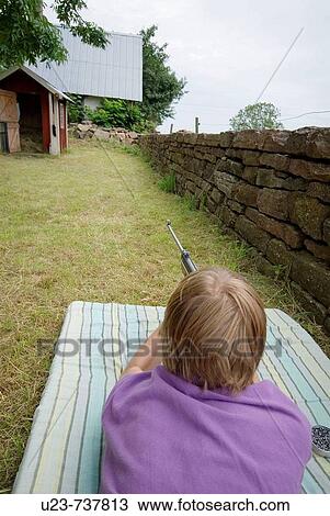 Boy aiming with an airgun. View Large Photo Image Stock Image - Boy aiming with an airgun.. Fotosearch