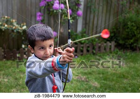 Boy aims with home-made bow and arrow. View Large Photo Image Stock Photo - Boy aims with home-made bow and arrow.. Fotosearch