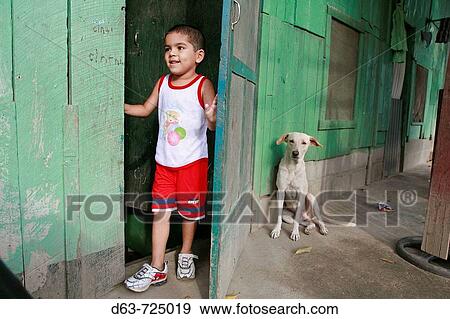 Boy and dog in the slum? barrio? of Chamelecon, San Pedro Sula, Honduras View Large Photo Image Stock Photo - Boy and dog in the slum? barrio? of Chamelecon, San Pedro Sula, Honduras. Fotosearch