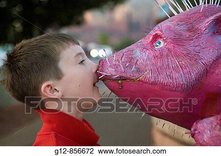 Stock Image - Boy and fake pig in Sedona, AZ.. Fotosearch