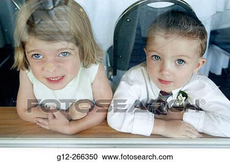 Boy and girl looking through the window View Large Photo Image Stock Image - Boy and girl looking through the window. Fotosearch