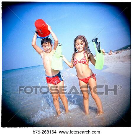 Boy and girl playing on the beach View Large Photo Image Picture - Boy and girl playing on the beach. Fotosearch