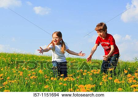 boy and girl playing with bubbles in field of Dandelions, Zuercher Oberland, Zuerich, Switzerland View Large Photo Image Picture - boy and girl playing with bubbles in field of Dandelions, Zuercher Oberland, Zuerich, Switzerland. Fotosearch