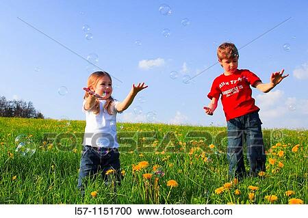boy and girl playing with bubbles in field of Dandelions, Zuercher Oberland, Zuerich, Switzerland View Large Photo Image Stock Image - boy and girl playing with bubbles in field of Dandelions, Zuercher Oberland, Zuerich, Switzerland. Fotosearch