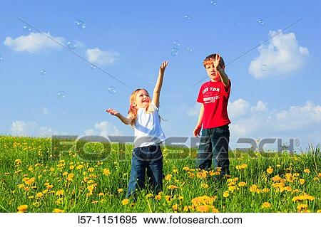 boy and girl playing with bubbles in field of Dandelions, Zuercher Oberland, Zuerich, Switzerland View Large Photo Image Stock Photography - boy and girl playing with bubbles in field of Dandelions, Zuercher Oberland, Zuerich, Switzerland. Fotosearch