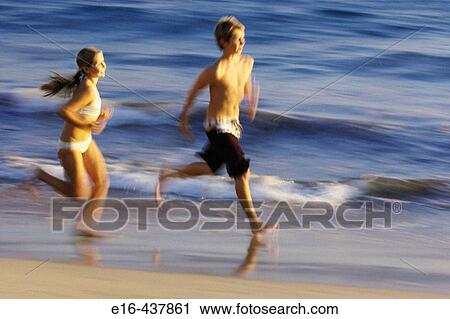 Boy and girl running at beach View Large Photo Image Stock Image - Boy and girl running at beach. Fotosearch