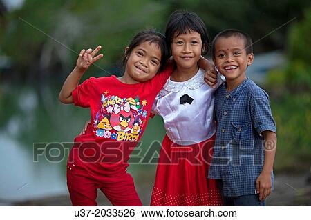 Boy and girls at Sematan fishing village, Sarawak, Malaysia. View Large Photo Image Stock Photograph - Boy and girls at Sematan fishing village, Sarawak, Malaysia.. Fotosearch