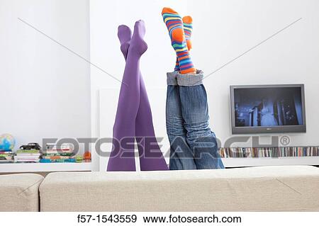 Boy and girls legs sticking up over a sofa View Large Photo Image Stock Photo - Boy and girls legs sticking up over a sofa. Fotosearch