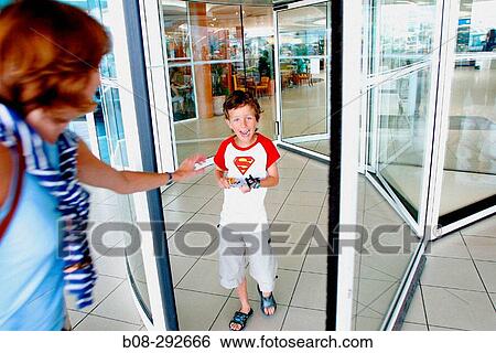 Boy and mum at supermarket door View Large Photo Image Stock Photograph - Boy and mum at supermarket door. Fotosearch