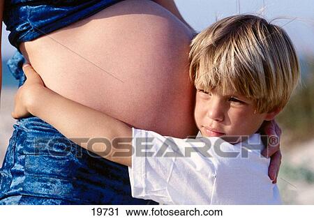 Stock Image - Boy and pregnant mother. Fotosearch