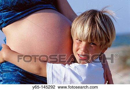 Stock Image - Boy and pregnant mother. Fotosearch