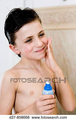 Boy applying perfume View Large Photo Image Stock Photo - Boy applying perfume. Fotosearch