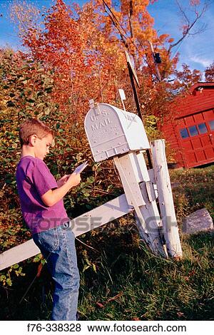 Stock Photo - Boy at mailbox. Lancaster. New Hampshire, USA. Fotosearch