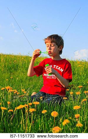 boy blowing bubbles in field of Dandelions, Zuercher Oberland, Zuerich, Switzerland View Large Photo Image Stock Image - boy blowing bubbles in field of Dandelions, Zuercher Oberland, Zuerich, Switzerland. Fotosearch