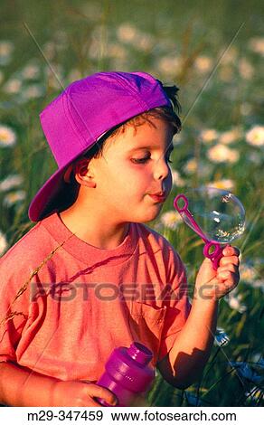 Stock Photo - Boy blowing bubbles. Fotosearch