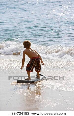 Boy boogie boarding, Maui, Hawaii, USA View Large Photo Image Stock Image - Boy boogie boarding, Maui, Hawaii, USA. Fotosearch