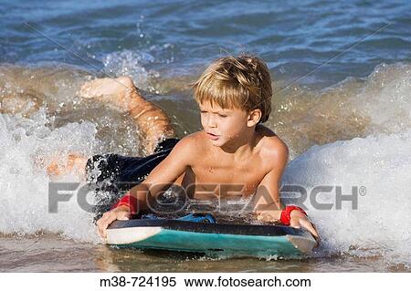 Boy boogie boarding, Maui, Hawaii, USA View Large Photo Image Stock Photography - Boy boogie boarding, Maui, Hawaii, USA. Fotosearch