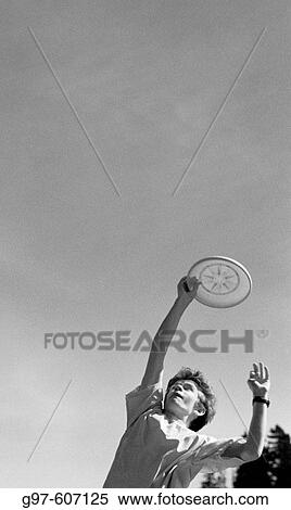 Boy catching frisbee View Large Photo Image Stock Photography - Boy catching frisbee. Fotosearch