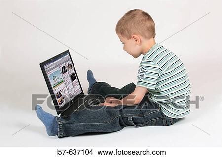 Boy child working on laptop computer, surfing on the internet, Studio, Oetwil am See, Zuerich, Switzerland View Large Photo Image Picture - Boy child working on laptop computer, surfing on the internet, Studio, Oetwil am See, Zuerich, Switzerland. Fotosearch