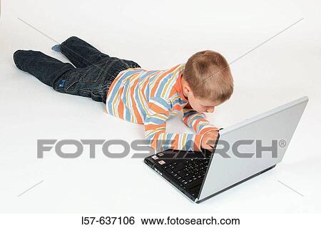 Boy child working on laptop computer, Studio, Oetwil am See, Zuerich, Switzerland View Large Photo Image Stock Photograph - Boy child working on laptop computer, Studio, Oetwil am See, Zuerich, Switzerland. Fotosearch