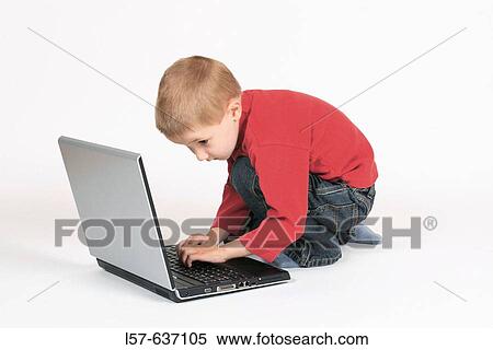 Boy child working on laptop computer, Studio, Oetwil am See, Zuerich, Switzerland View Large Photo Image Stock Photography - Boy child working on laptop computer, Studio, Oetwil am See, Zuerich, Switzerland. Fotosearch