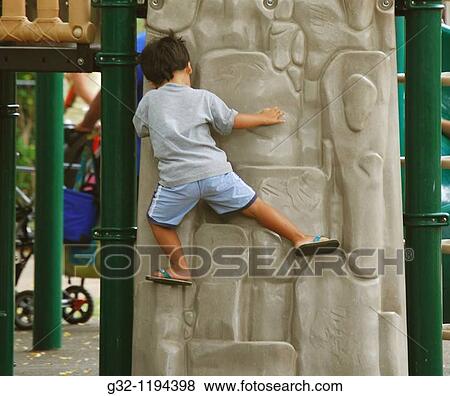 Boy climbs at playground View Large Photo Image Stock Photo - Boy climbs at playground. Fotosearch