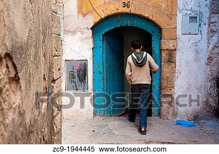 Boy coming in his home in Essaouira medina, Morocco. View Large Photo Image Stock Photography - Boy coming in his home in Essaouira medina, Morocco.. Fotosearch